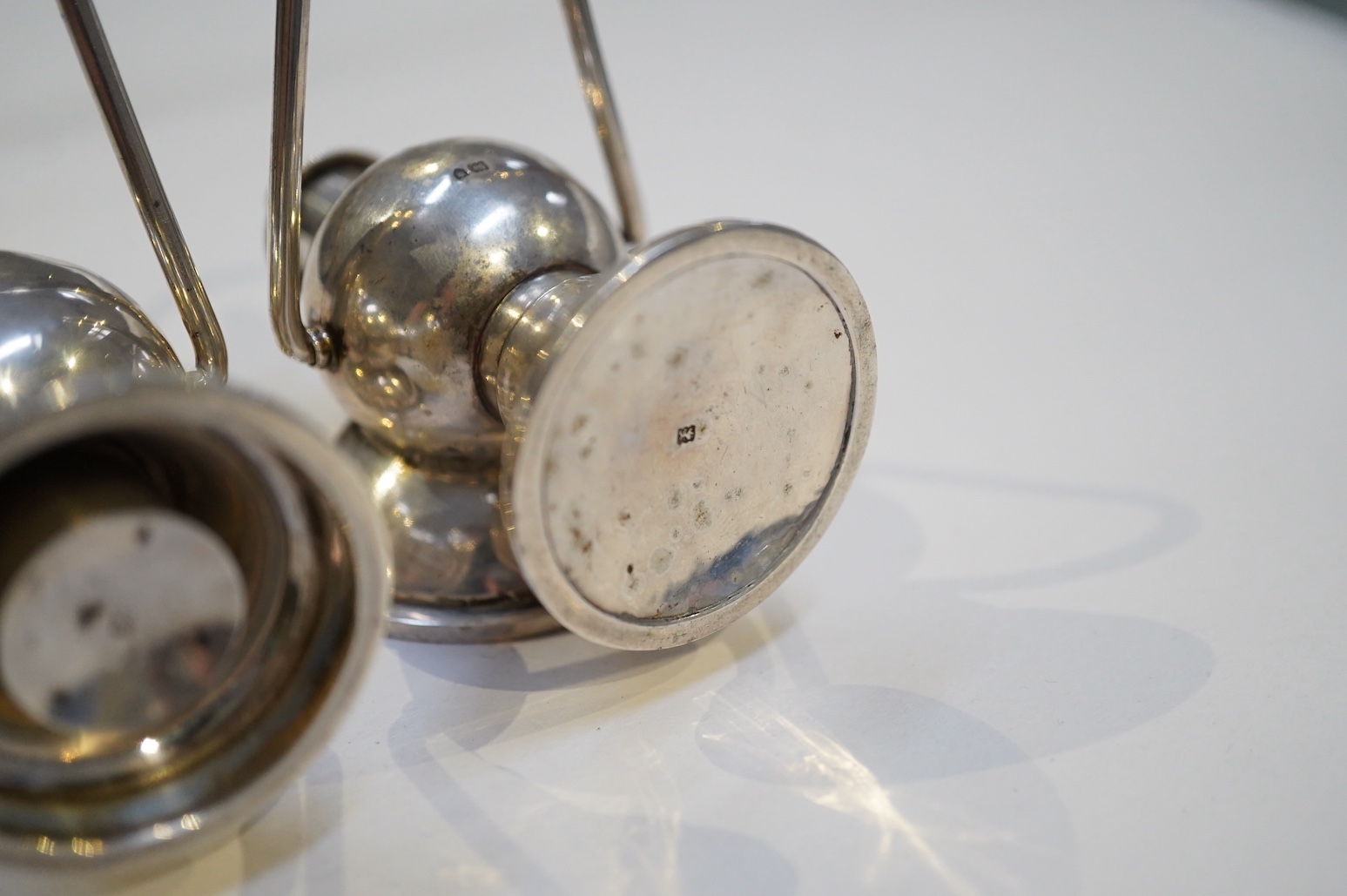 An Edwardian novelty cigar cutter and perpetual lighter, modelled as a pair of railway lamps, by Walker & Hall